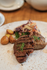 fried veal steaks and fried baby potatoes with salad