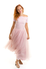 Naklejka premium A beautiful young woman stands in the wind, the wind moves her c