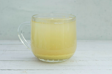 Cup of ginger tea isolated on white