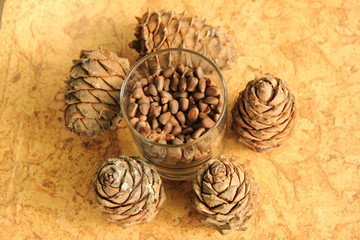 Siberian pine nuts in a glass jar on the wood background