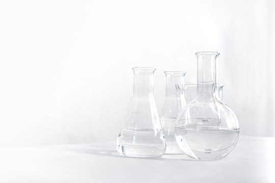 Science laboratory chemical beaker, Erlenmeyer and round flask lab glassware equipment. Research and development concept.