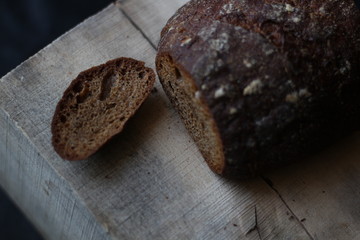 rye bread on a wooden background with a cut off crust