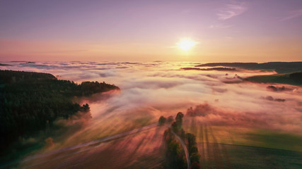 Fototapeta na wymiar beautiful view over the fog on the autumnal Bavarian forest in the sunset 