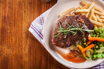 Beef steak served with baked potatoes