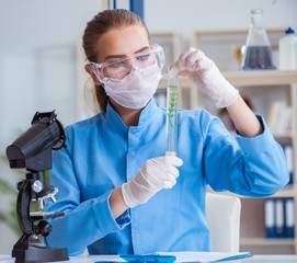 Female scientist researcher conducting an experiment in a labora