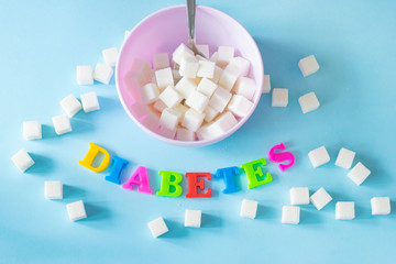 A lot of refined sugar on the blue table background.
