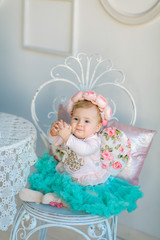 Image of sweet baby girl in a wreath, closeup portrait of cute 8 month-old smiling girl,  toddler.