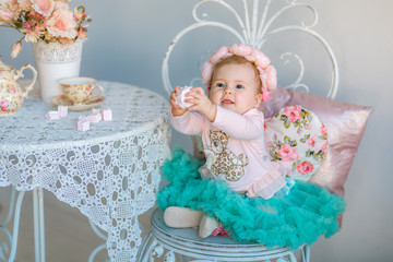 Image of sweet baby girl in a wreath, closeup portrait of cute 8 month-old smiling girl,  toddler.