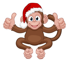 A Christmas monkey animal cartoon character in a Santa hat giving two thumbs up
