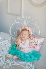 Image of sweet baby girl in a wreath, closeup portrait of cute 8 month-old smiling girl,  toddler.