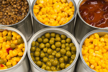 Canned food on white background. Green pea, beans, corn, lentils.