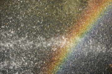 Rainbow in sparkling drops of water in the sunlight. Abstract photo, screen saver or background for your ideas.