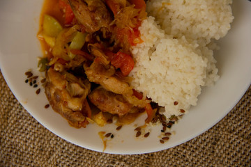 rice and vegetable stew with chicken meat on a white plate. Home cooked food. Asian recipes