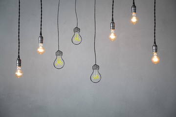 Idea concept - light bulbs against grey background