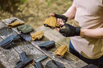 guy in the woods tests his weapons for shooting sports