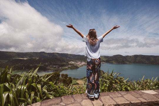 Woman enjoy beautiful mountains lake landscape standing hands up
