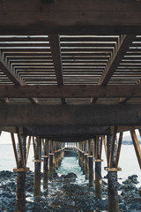 landscape of a dock of wood on the sea in a rocky and beautiful place - nobody at the place and bad weather - Lanzarote, Canary Island