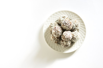 Energy balls on a white bowl on a white background