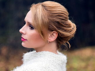 Portrait of a girl in a festive hairstyle and makeup