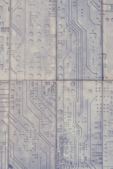 The texture of a stone wall with a carved pattern of a digital computer chip