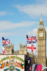 Colorful souvenir stand brightening up the view of Big Ben and Westminster Palace on a sunny day in London, UK