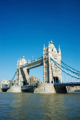 Bright sunny daytime view of Tower Bridge with clear blue sky above the River Thames in London, UK