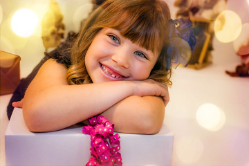 beautiful girl waiting for the opening of gifts