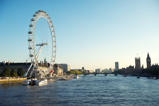 Bright Afternoon View Of The London Skyline From Waterloo Bridge Including Silhouettes Of Westminster Palace And The South Bank Of The River Thames Under Clear Blue Sky