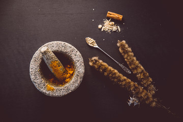Top-down view with organic herbs and CBD related natural medicine. such as  ingredients such as turmeric, ginger, cinnamon, aloe vera and poppy seeds.