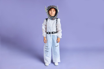 Caucasian little boy in white protective suit stand isolated over copy space, look at camera © alfa27