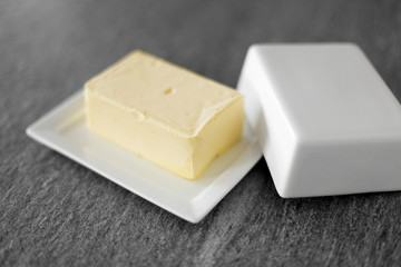 food and dairy products concept - close up of butter on stone table