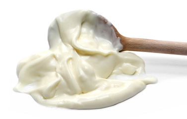 Mayonnaise puddle with wooden spoon isolated on white background