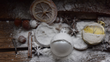 Fototapeta na wymiar Christmas still life Christmas decorations balloon orange clock snow and powdered sugar