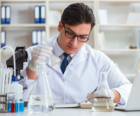 Fototapeta premium Young researcher scientist doing a water test contamination expe
