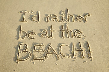 I'd Rather Be At The Beach message handwritten in clean sand