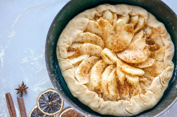 Homemade apple tart on kitchen table. Apple galette with cinnamon
