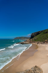Fototapeta na wymiar Beautiful tropical beach background with mountains and sandy shore