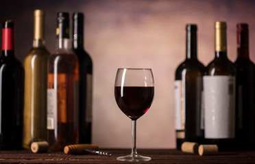 Red Wine in glass and bottles on a dark background with copy space