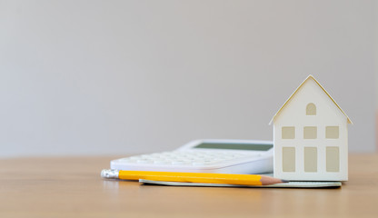 close up front view group of  home model with calculator , yellow pencil, banking account book and...