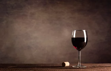 Fotobehang Red Wine in glass on a dark background with copy space © nikilitov