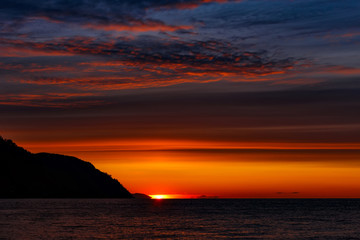 Colorful sunrise at Baikal lake with blue and red clouds