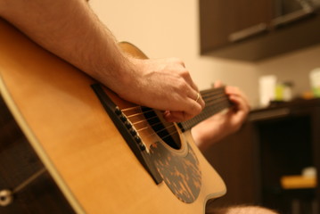 a man plays the guitar, the fretboard, strings