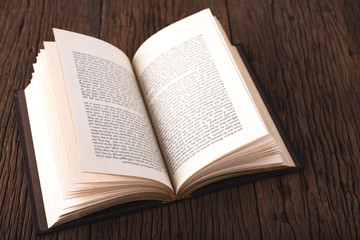 Obraz premium A book on a wooden top view table with a copyspace for your text