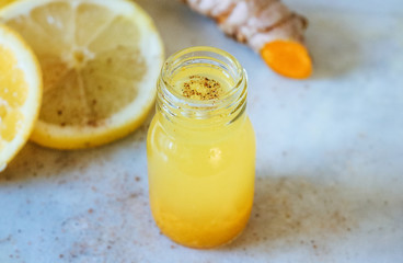 Close up of a lemon and Turmeric shot
