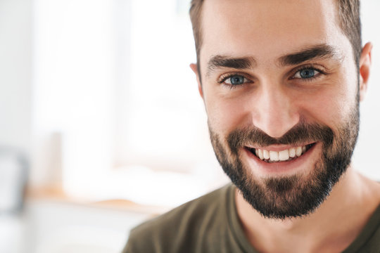 Image closeup of caucasian happy man looking and smiling at camera