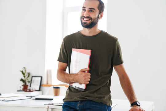 Image Of Caucasian Happy Man Holding Brochure And Smiling