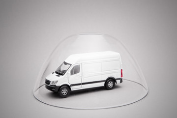 Truck under the glass dome. The concept of safe transportation of goods.