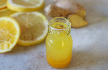 Close up of a small lemon and ginger shot