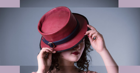 woman with curly hair in a red hat