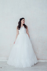 Fototapeta premium bride in white wedding dress in a roomf wedding